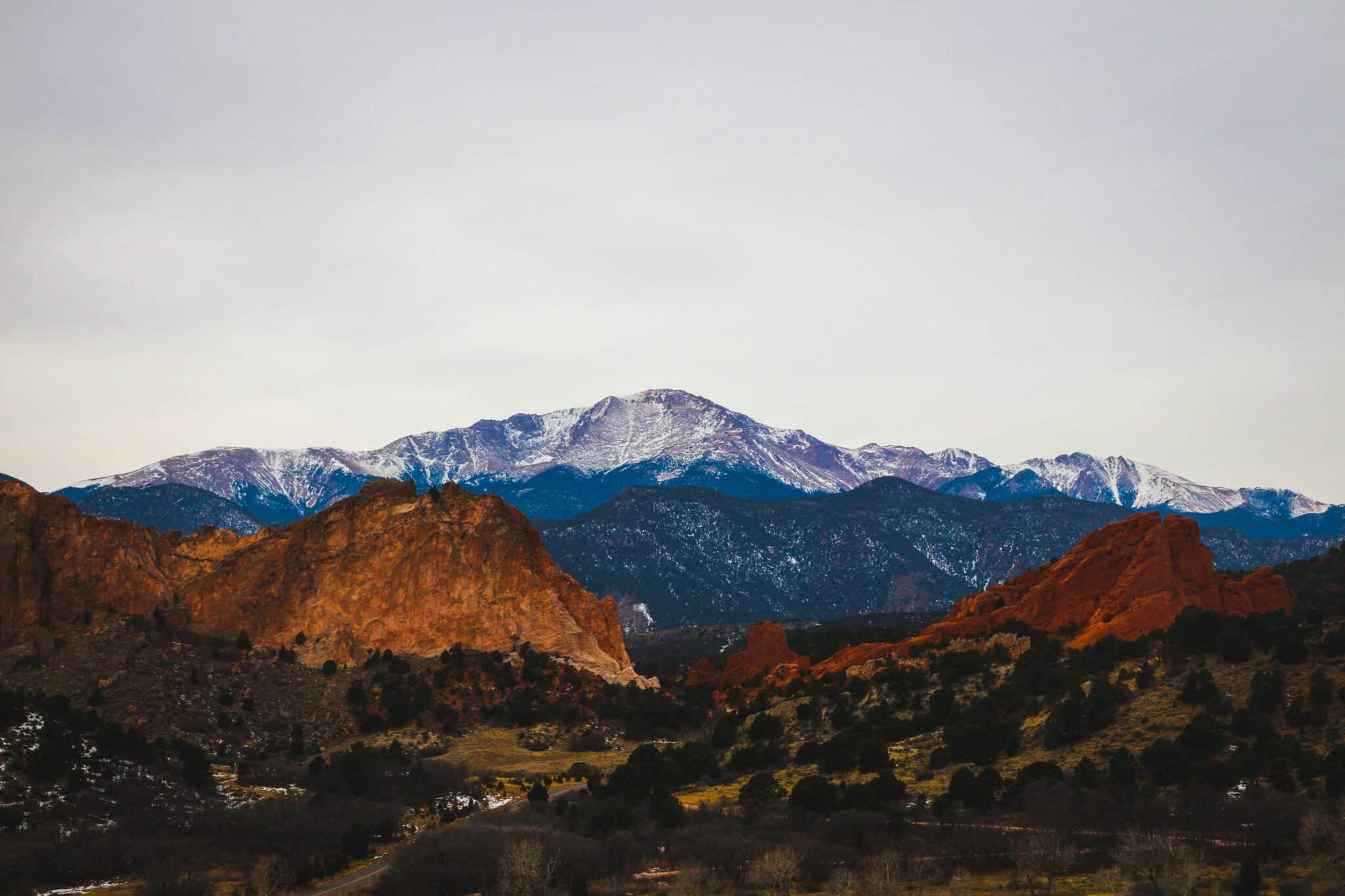 Snowy Pikes Peak above the red rocks of Garden of the Gods, near sober living Colorado Springs homes.