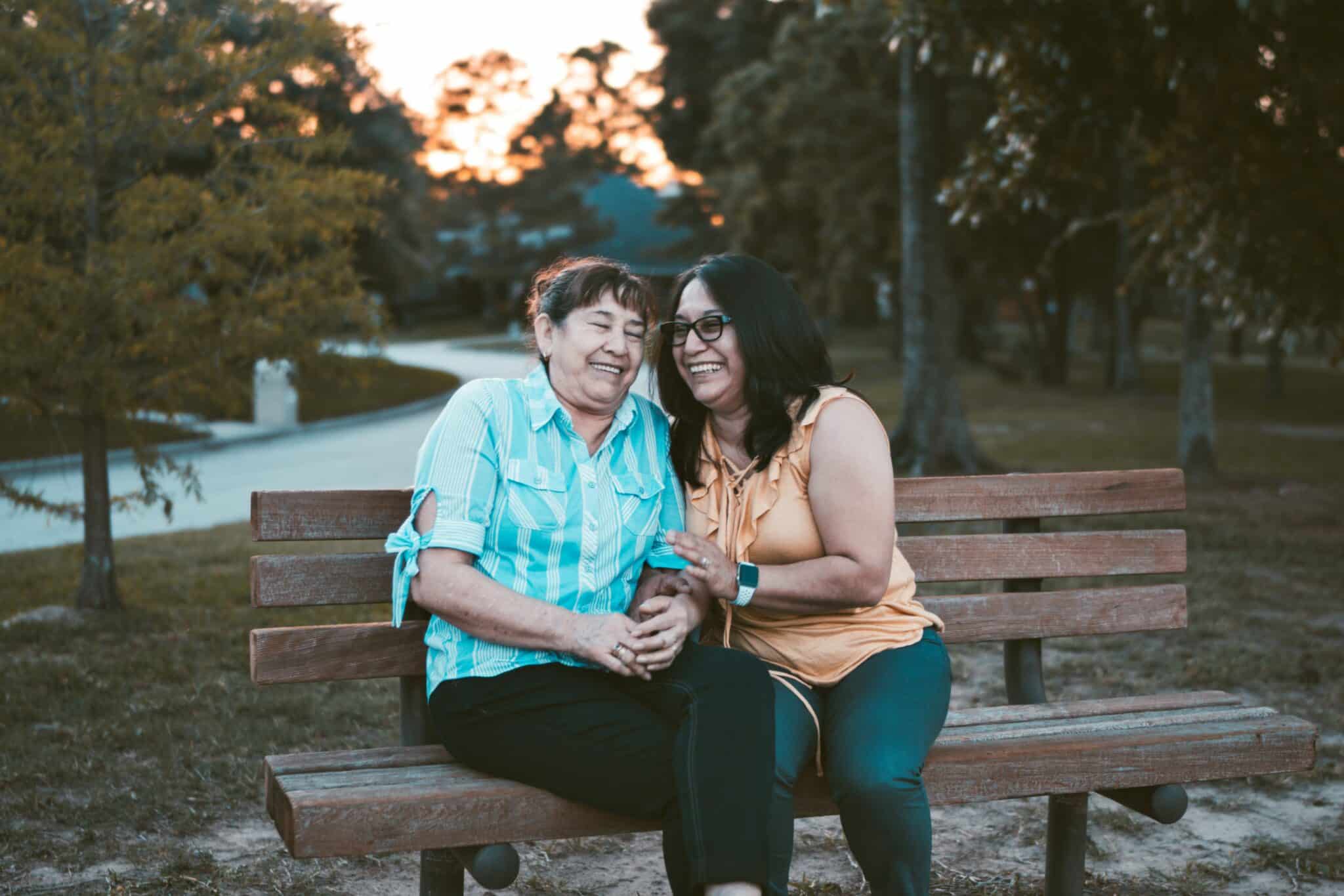 Family laughing together outdoors representing supportive recovery environment.