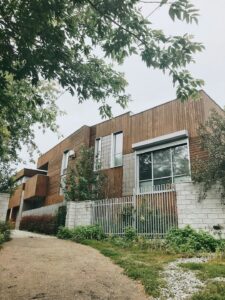 a house with a white fence and trees -- Photo by Ruslan Fatihov on Unsplash