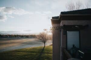 man in black shirt sitting on brown wooden bench near body of water during daytime -- Photo by Anna Hecker on Unsplash