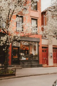 A restaurant is nestled beneath blooming trees. -- Photo by Damian Kravchuk on Unsplash