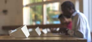 a man sitting at a table next to a white object -- Photo by Matt Hoffman on Unsplash