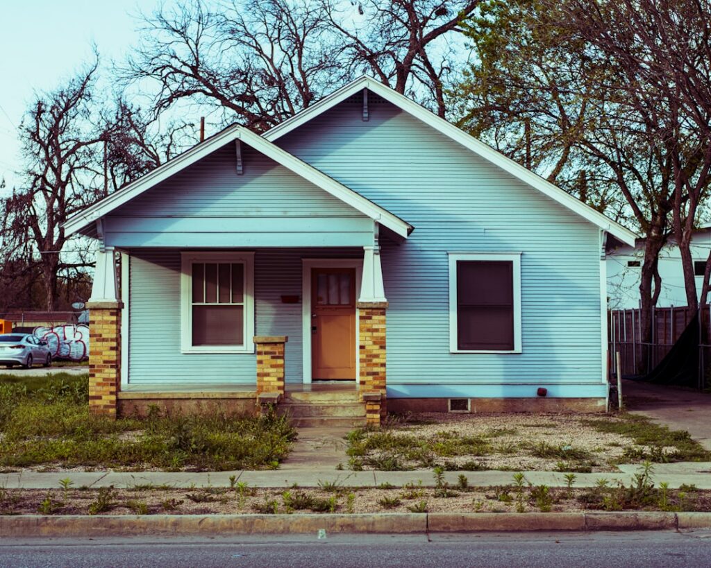 a small blue house with a yellow door -- Photo by Christopher Holmok on Unsplash