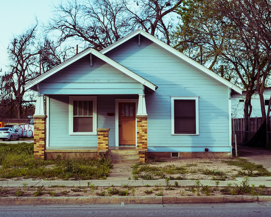 a small blue house with a yellow door -- Photo by Christopher Holmok on Unsplash
