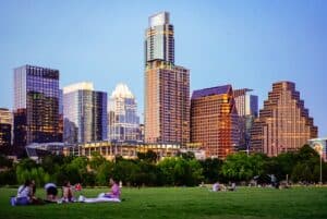people sitting on green grass field near city buildings during daytime -- Photo by Megan Bucknall on Unsplash