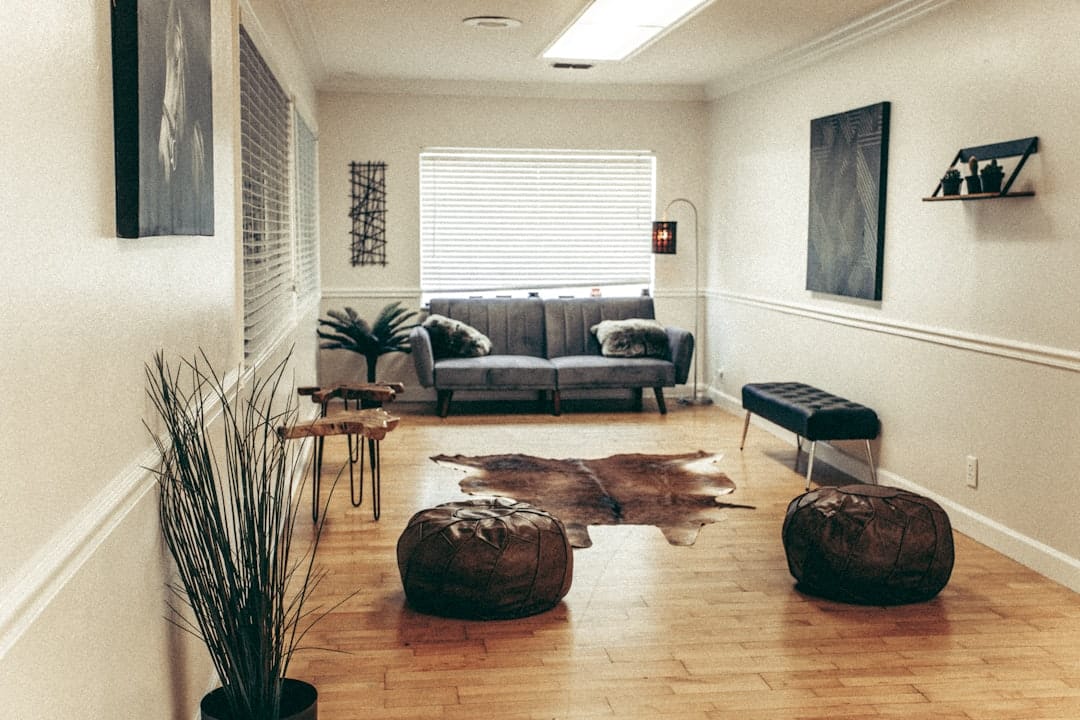 black leather sofa near brown wooden coffee table -- Photo by Cherosi on Unsplash