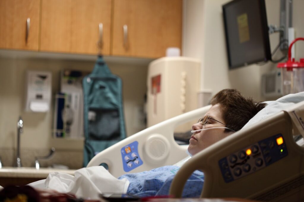 boy lying on beige recliner hospital bed -- Photo by Alexander Grey on Unsplash