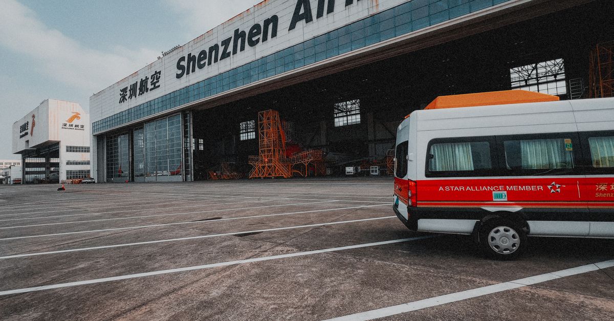 Shenzhen Airlines hangar with a parked van depicting air travel infrastructure.