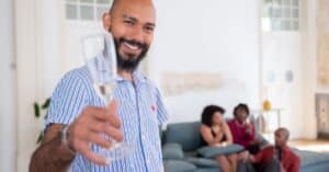 Enjoying a joyful home gathering in Portugal with friends, drinks in hand and smiles all around.