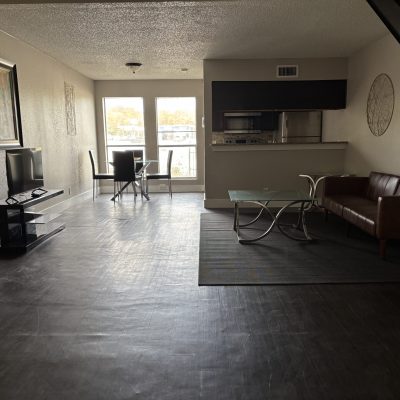 Entry area in Austin men’s sober living home with yellow chairs and natural light