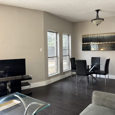 Affordable shared living area in Austin men’s sober apartment with sofa and TV