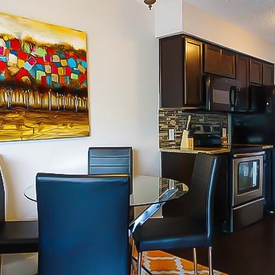 Dining area and modern kitchen in men’s sober living apartment at Eudaimonia Recovery Homes in Austin, TX.